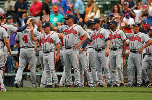 Players and coaches for the Atlanta Braves celebrate a win against the Chicago Cubs at Wrigley Field on September 20, 2013 in Chicago, Illinois. The Braves beat the Cubs 9-5. <br/>