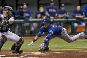 Tampa Bay Rays catcher Jose Lobaton (L) reaches for the throw to the plate as Texas Rangers' Leonys Martin (R) scores on Elvis Andrus' sacrifice fly to right field during the fifth inning of their MLB American League baseball game in St. Petersburg, Florida, September 17, 2013.(Photo : Reuters) <br/>