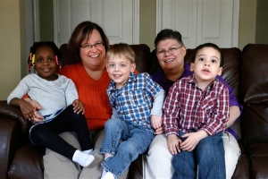 April DeBoer, second from left, sits with her daughter Ryanne, 3, left, and Jayne Rowse, fourth from left, and her sons Jacob, 3, middle, and Nolan, 4, right, at their home in Hazel Park on March 5, 2013. (AP Photo/Paul Sancya) <br/>