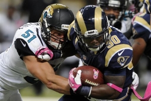 St. Louis Rams running back Zac Stacy, right, runs with the ball as Jacksonville Jaguars linebacker Paul Posluszny defends during the second quarter of an NFL football game Sunday, Oct. 6, 2013, in St. Louis.  <br/>L.G. PATTERSON/AP 