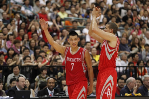 Houston Rockets Jeremy Lin (7) cheers with Francisco Garcia after scoring against the Indiana Pacers during a preseason game in Taipei, Taiwan, Sunday, October 13, 2013. The Rockets beat the Pacers 107-98.  <br/>(AP Photo/Wally Santana)