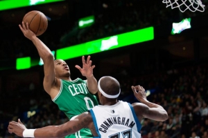 Boston Celtics' Avery Bradley, left, takes a shot on net as Minnesota Timberwolves' Dante Cunningham defends during the second quarter of an NBA preseason basketball game in Montreal, Sunday, Oct. 20, 2013. (AP Photo/The Canadian Press, Graham Hughes) <br/>