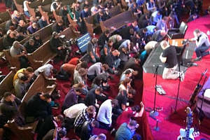 Pastors praying on their knees and faces after listening to Rick Warren speak at the Resurgence Conference 2013 in Seattle on Nov. 6, 2013.  <br/>Resurgence Conference 2013
