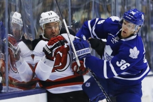 Ilya Kovalchuk hits the boards, courtesy of the Maple Leafs' Carl Gunnarsson. <br/>MARK BLINCH/REUTERS