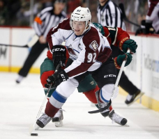 Colorado Avalanche winger Gabriel Landeskog brings the puck up the ice ahead of Minnesota Wild center Torrey Mitchell January 19, 2013.  <br/>(REUTERS/Eric Miller)