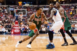 Bucks guard Brandon Jennings is defended by Philadelphia guard Royal Ivey during the second quarter at the Wells Fargo Center. Jennings was benched in the third quarter. <br/>Reuters