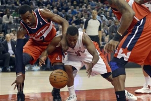 Toronto Raptors Kyle Lowry (3) is fouled by Washington Wizards John Wall (2) during the first half of their NBA basketball game in Toronto, February 25, 2013. <br/>CREDIT: REUTERS/AARON HARRIS