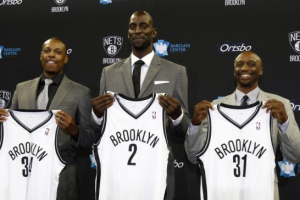 Newly acquired Brooklyn Nets players Paul Pierce, Kevin Garnett and Jason Terry hold up their new jerseys after a news conference to introduced them to the media [Photo: REUTERS/Adam Hunger] <br/>