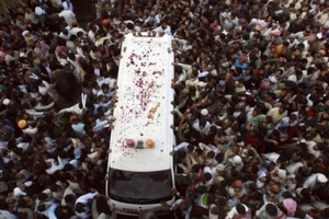 Supporters of Pakistan's former Prime Minister Benazir Bhutto surround their leader's dead body in an ambulance upon arrival for burial at her ancestral grave yard in Gari Khuda Bux near Larkana, Pakistan on Friday, Dec. 28, 2007. Bhutto was killed along with 20 others, Thursday in a suicide attack. <br/>(Photo: AP Images / Shakil Adil)