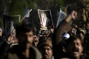 Supporters of slain opposition leader Benazir Bhutto hold photos of her as they march during a demonstration in Rawalpindi near Islamabad, Saturday, Dec. 29, 2007. Mass rioting following the assassination of opposition leader Benazir Bhutto has led to the deaths of 38 people and caused tens of millions of dollars in damage, the government said Saturday. <br/>(Photo: AP Images / Emilio Morenatti)