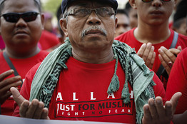 Muslim demonstrators prayed outside the Court of Appeal near Kuala Lumpur on Oct. 14 following a ruling that banned the Catholic Church from using the word Allah to refer to God in its newspaper.  <br/>Associated Press
