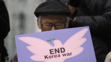 A South Korean protester closes his eye as he holds sign during a press conference denouncing the UN’s new sanction and the annual joint military exercises, dubbed Key Resolve and Foal Eagle, between South Korea and the United States, near the U.S. Embassy in Seoul, South Korea, Friday, March 8, 2013. (AP Photo/Lee Jin-man) <br/>
