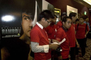 Members of the Overseas Burmese Patriots (OBP) wait before a screening of Rambo IV in Singapore February 3, 2008. The OBP booked 600 seats for a screening of the film at a cinema in Singapore. The bloodiest Rambo film so far shows John Rambo fighting the Myanmar military to free a group of Christian aid workers in the jungles of Eastern Myanmar. <br/>(REUTERS/Charles Pertwee ) 