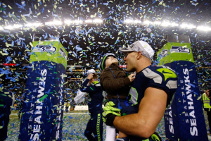 Seattle Seahawks player Chris Maragos celebrates with his child after the Seahawks 23-17 victory against the San Francisco 49ers during the 2014 NFC Championship on January 19, 2014 in Seattle, Washington. (Photo: Jonathan Ferrey/Getty Images) <br/>