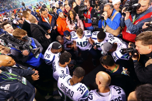 Feb 2, 2014; East Rutherford, NJ, USA; Seattle Seahawks quarterback Russell Wilson (3) kneels in prayer with his teammates after Super Bowl XLVIII against the Denver Broncos at MetLife Stadium. Mandatory Credit: Mark J. Rebilas-USA TODAY Sports <br/>