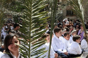 Churchgoers wave palm fronds on Palm Sunday at the Fatima Church in downtown Damascus, Sunday March 16, 2008. Palm Sunday commemorates Jesus Christ's triumphant entry into Jerusalem and is the start of the church's most solemn week, which includes the Good Friday re-enactment of Christ's crucifixion and death and his resurrection on Easter Sunday. <br/>(Photo: AP Images / Bassem Tellawi) 