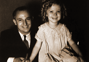 Contract signed. Shirley Temple and her father at Fox studio, summer 1934. (Twentieth Century-Fox) <br/>