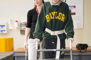Makenzie Wethington walks during a physical therapy session at the Baylor Institute for Rehabilitation in Dallas on Monday. (AP) <br/>