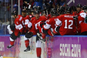 Canada's players celebrate their men's ice hockey semi-final victory over Team USA at the Sochi 2014 Winter Olympic Games, February 21, 2014. REUTERS/Laszlo Balogh <br/>