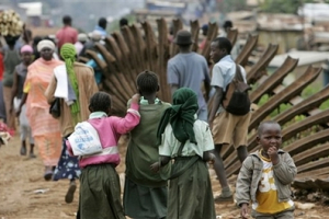Children walk past a destroyed railway line in the Kibera slum in Nairobi , Kenya Thursday, April 10, 2008 that was destroyed by a crowd protesting the delays in forming a coalition government. <br/>: AP Images / Karel Prinsloo