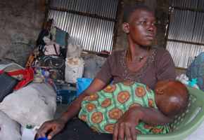 A displaced woman with her baby sits among her belongings at a transit camp in Kisumu, Kenya, on Wednesday, Feb. 13, 2008. 600,000 people fled their homes because of violence sparked by a dispute over who won Kenya's Dec. 27 presidential election according to a United Nations report. <br/>(Photo: AP Images / Riccardo Gangale)