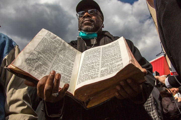 Pastor Vernon Williams holds a bible that survived the explosion at the Spanish Christian Church in Harlem