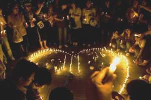 Chinese people light candles to mourn for the Sichuan earthquake dead on the last evening of three days of national mourning in Beijing, China, Wednesday, May 21, 2008. <br/>(Photo: AP Images / Alexander F. Yuan)