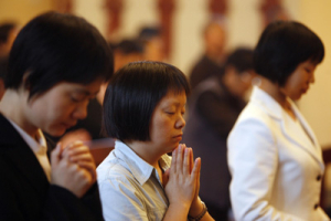 Women pray in a church in Chengdu during a special gathering for victims of last week's earthquake in Sichuan province May 23, 2008. Elderly Catholics gathered in Chengdu on Friday to pray for brethren in stricken parishes, while priests and nuns took food to refugees in crowded stadiums or mountain towns. Historic churches in steep mountain towns are among the casualties of the earthquake that devastated China's Sichuan province last week, leaving their poor and rural Catholic congregations with little but faith. <br/>(REUTERS/Nir Elias ) 