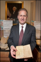 Steve Green displays a rare Bible from his collection.   <br/>the Green Collection