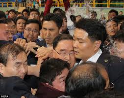 An angry bystander hurls a water bottle at a South Korean government official <br/>