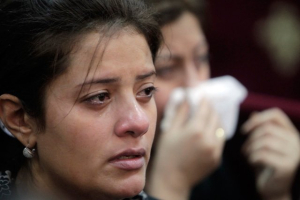 An Egyptian Christian woman mourns the death of an eight-year old Christian girl who was killed, along with three others, by Islamist gunmen as they were waiting outside a church for a wedding to begin. <br/>