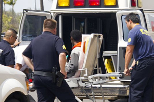 A 16-year-old boy who stowed away in the wheel well of a flight from San Jose, Calif., to Maui, on stretcher at center, is loaded into an ambulance at Kahului Airport in Kahului, Maui, Hawaii Sunday afternoon, April 20, 2014.  <br/> Chris Sugidono, AP