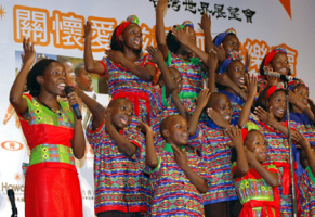 In this April 2006 photo, Ugandans of the Watoto Children's Choirs perform in Taiwan on invitation by World Vision. World Vision Taiwan brought a delegation of religious leaders to Uganda, Sunday, in an effort to raise AIDs and poverty awareness. <br/>