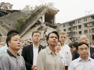 United States Secretary of State Condoleezza Rice looks at destroyed buildings in earthquake-hit Dujiangyan in Sichuan Province yesterday. During her four-hour stay in the province, Rice also toured temporary homes for survivors and saw a water purifier donated by Samaritan's Purse, a US non-governmental organization. She presented a book on US national parks to a 14-year-old boy, Zhou Yifan, after they chatted together in English. She inscribed the book with a message of good wishes. Rice was the highestranking US official to visit the area hit by the quake that killed almost 70,000 people. <br/>(Shanghai Daily)
