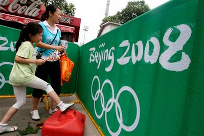 Bystanders watch Shanghai Stadium, one of remote venues of Beijing Olympics, in Shanghai, China Wednesday July 30, 2008. <br/>(Photo: AP Images /Eugene Hoshiko)