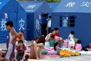 In this photo released by China's official Xinhua News, evacuees, with no tents available, rest outdoor on a square in the Yi Autonomous County of Ning'er of Pu'er City, southwest China's Yunnan Province on Sunday June 3, 2007. <br/>Xinhua, Qin Qing