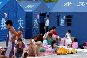 In this photo released by China's official Xinhua News, evacuees, with no tents available, rest outdoor on a square in the Yi Autonomous County of Ning'er of Pu'er City, southwest China's Yunnan Province on Sunday June 3, 2007. <br/>Xinhua, Qin Qing
