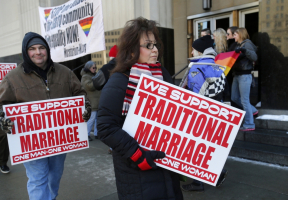 Protestors opposed to same-sex marriage carry signs outside the Federal Court House in Michigan where plaintiffs April Deboer and her same-sex partner Jayne Rowse managed to overturn Michigan's ban on same-sex marriage in Detroit, Michigan in a ruling on Friday March 21, 2014.  (Photo: Reuters/Rebecca Cook) <br/>