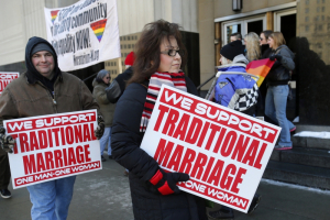 Protestors opposed to same-sex marriage carry signs outside the Federal Court House in Michigan where plaintiffs April Deboer and her same-sex partner Jayne Rowse managed to overturn Michigan's ban on same-sex marriage in Detroit, Michigan in a ruling on Friday March 21, 2014.  (Photo: Reuters/Rebecca Cook) <br/>