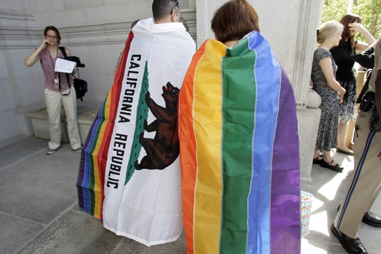 Gay rights supporters wear a California state flag,left, and a gay pride flag outside of the California State Supreme Court building in San Francisco, Thursday, May 15, 2008, after the Court ruled in favor of the right of same sex couples to wed. <br/>(Photo: AP Images / Paul Sakuma)