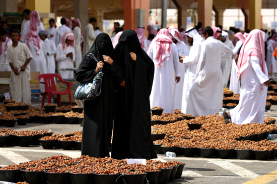 Saudi women buy dates, at Unayzah market around 400 km north of the capital Riyadh, Saudi Arabia, Sunday Aug.31, 2008, a day before the start of the holy Muslim fasting month of Ramadan. Saudi Arabia, the birthplace of Islam, declared tomorrow to be the kingdom’s first day of the holy month, during which Muslims are required to abstain from food, drink and sex from dawn until dusk. <br/>(Photo: AP Images / Hassan Ammar)