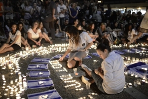 Israelis light candles in Tel Aviv's Rabin Square on Monday as they mourn the news of the death of three abducted Jewish teenagers. Israeli forces found the bodies of the three missing teenagers on Monday after a nearly three-week-long search. (Tomer Neuberg/Flash90) <br/>