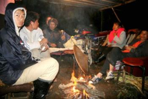 In this photo released by China's Xinhua News Agency, residents gather around a bonfire as they evacuate following an earthquake in Yinlu Village, Datian Town, Renhe District of Panzhihua City, southwest China's Sichuan Province, Sunday, Aug. 31, 2008. Rescue teams headed to China's southwestern Sichuan province after a 6.1-magnitude earthquake killed 22 people and injured hundreds, local authorities said Sunday. <br/>(AP Photo/Xinhua News Agency, Chen Haining)