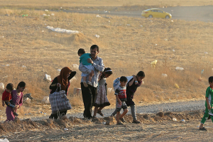 A family walks toward a temporary camp in Iraq's northern Nineveh province on June 14. (NBC News) <br/>