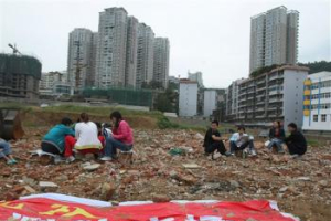 Chinese residents take temporary shelter at a construction site with a banner reads <br/>(AP Photo/Color China Photo) CHINA OUT