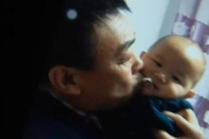 Pastor Shaojie kissing his granddaughter. <br/>Sky News