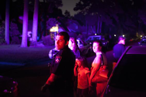 A Harris County officer has to turn residents away from the crime scene after several people were shot to death in the Houston suburb of Spring Texas July 9, 2014. Reuters <br/>
