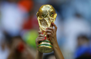 A fan holds up a trophy before the 2014 World Cup Group D soccer match between England and Italy at the Amazonia arena in Manaus on June 14, 2014. (Ivan Alvarado—Reuters) <br/>