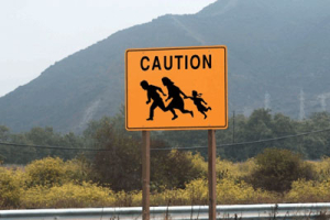A sign cautioning the illegal border crossing of immigrants is placed prominently near the Texas/Mexico border. (AP) <br/>