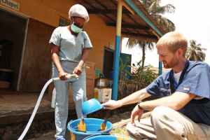 Dr. Brantly, who was infected with Ebola, makes chlorine solution for disinfection at the case management center at ELWA Hospital. <br/>Samaritan's Purse